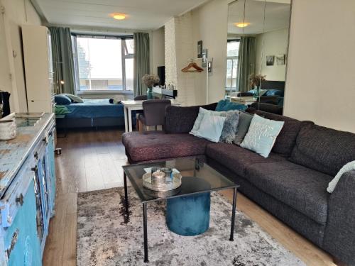 a living room with a couch and a table at City Center Rooms with Shared Facilities by UMCG in Groningen