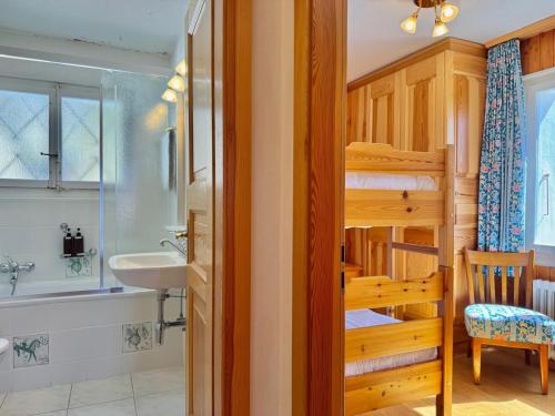 a bathroom with a bunk bed and a sink at Chalet Le Nid D'argent - Dans la nature in Crans-Montana