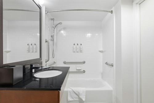 a white bathroom with a sink and a shower at Fairfield by Marriott Inn & Suites Wallingford New Haven in Wallingford