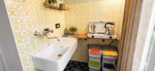 a small bathroom with a sink and a mixer at Lavanda Cozy Apartment near Lake Como and Lugano in Lanzo dʼIntelvi