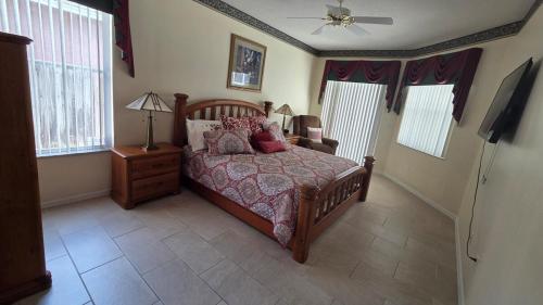 a bedroom with a bed and a television in it at Accessible-Friendly Pool Retreat Extended Stay Welcome in Valrico