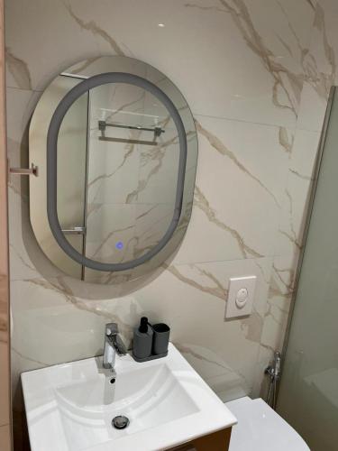a bathroom with a sink and a mirror at Irene's rooms in Himare