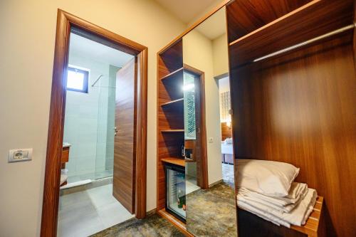 a bathroom with a walk in shower and a mirror at Hotel Ryon Mamaia-Nord in Mamaia Sat/Năvodari