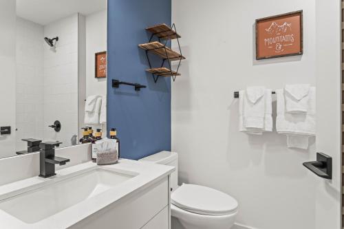 a bathroom with a white toilet and a sink at Golden Ridge Collection in Canmore