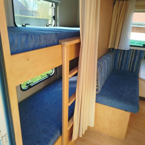a room with two bunk beds and a window at Caravane in Port-sur-Saône