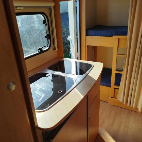 a kitchen in an rv with a sink at Caravane in Port-sur-Saône