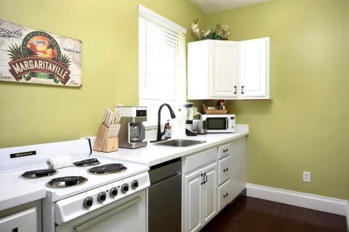 a kitchen with a stove and a sink at Duval Street Suite w kitchen and shared heated pool in Key West