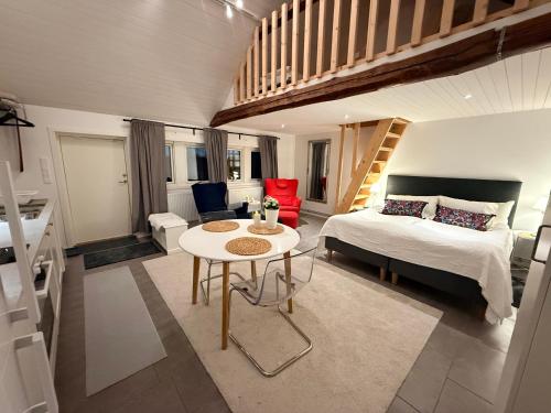 a bedroom with a bed and a table in a room at Kinnekulle bed & breakfast in Källby