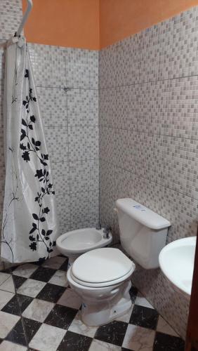 a bathroom with a toilet and a sink at Tinkunaco in Purmamarca