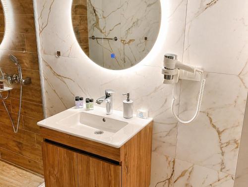 a bathroom with a sink and a mirror at Lungolago Apartment Ohrid in Ohrid