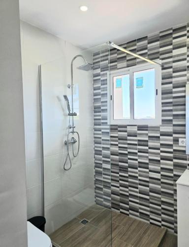 a bathroom with a shower with a glass door at Villa Los Naranjos in Carcaixent