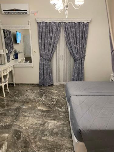a bedroom with a bed and a desk and a mirror at Dionisia Apartments in Kefalos