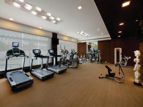 a gym with treadmills and elliptical machines at Orange Megastructure LLP in Surat