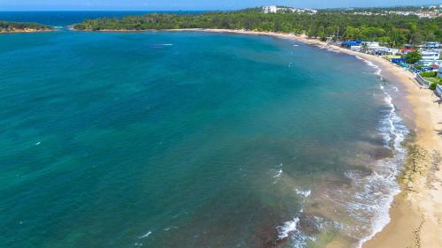 an aerial view of a beach and the ocean at Balandras Beach Stay 1 Beach & Pool Access in Dorado