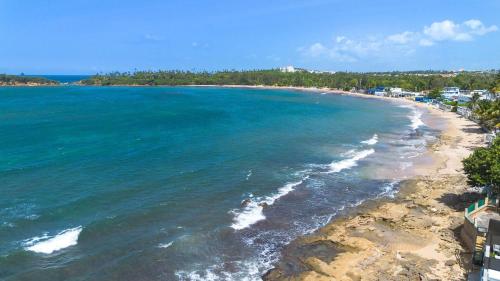 an aerial view of a beach and the ocean at Balandras Beach Stay 3 Beach & Pool Access in Dorado