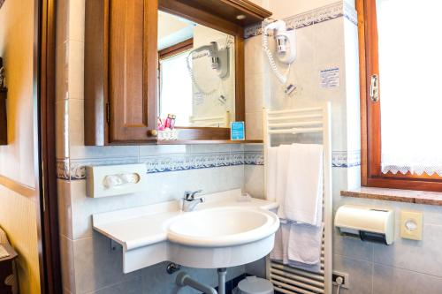 a bathroom with a sink and a mirror at Hotel Petit Prince in Antagnod