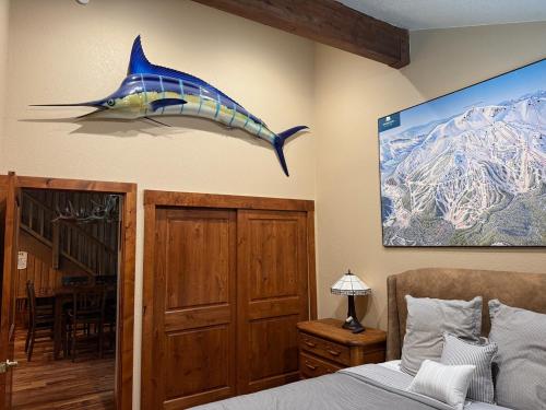 a blue shark hanging on the wall of a bedroom at Mountainback 79 Loft Den in Mammoth Lakes