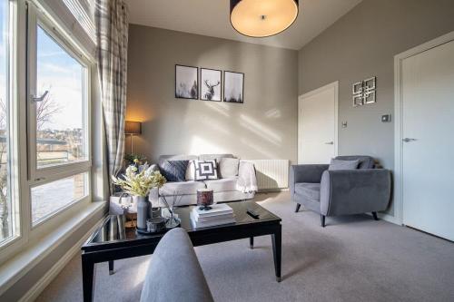 a living room with a couch and a table at Stirling Riverview Apartment - Free Parking in Stirling