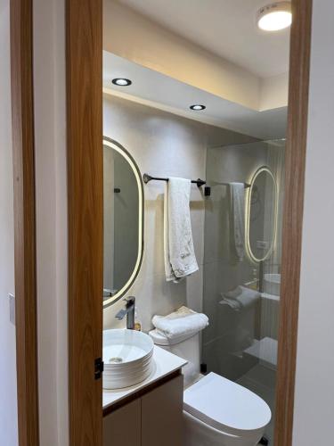 a bathroom with a toilet and a sink and a shower at Boreal House in Manizales