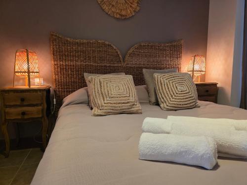 a bed with two white pillows and two lamps at Albatros in Lourdes