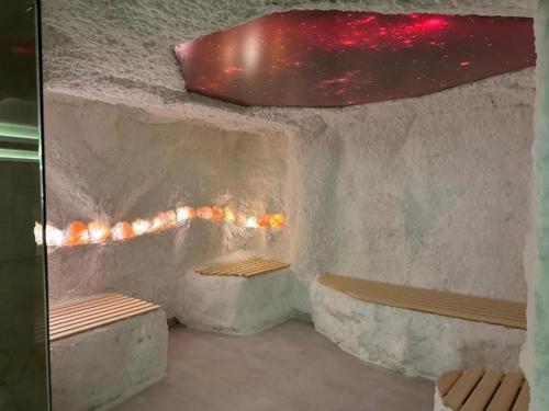 a room with two benches and a rock wall at Kopaonik Mountain Retreat in Cajetina