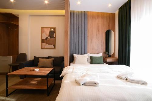 a hotel room with a bed and a table at Kopaonik Mountain Retreat in Cajetina