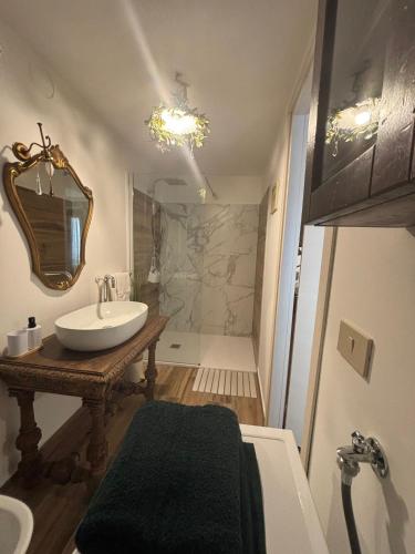 a bathroom with a sink and a shower at Casa Di Orfea in Perosa Argentina