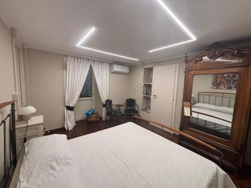 a bedroom with a bed and a mirror in it at Casa Di Orfea in Perosa Argentina