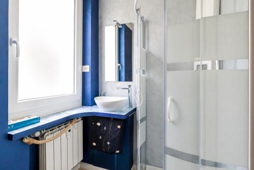 a bathroom with a sink and a shower at Blu Marina Alassio in Alassio