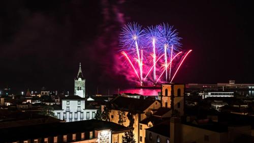 a fireworks display over a city at night at The Plaza Apartment in Funchal