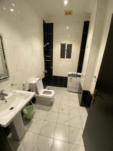 a white bathroom with a sink and a toilet at تميز المروة - حي المروة in Jeddah