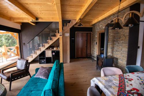 a living room with a couch and a staircase at Vila Planinski Vuk Zlatar Nova Varoš in Vukovina