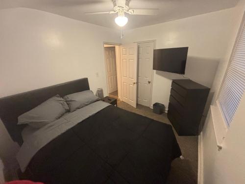 a bedroom with a bed and a flat screen tv at Peace & Relax sensation in Washington, D.C.