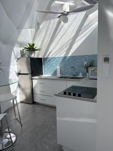 a kitchen with white appliances and a ceiling fan at Mod Squad in Saint Jo
