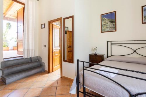 a bedroom with a bed and a door to a balcony at Case Vacanze Albamarina in Lipari