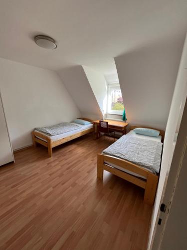 a room with two beds and a window at Guestroom Hannover Messe in Hannover
