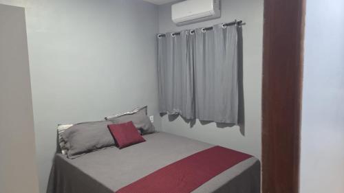 a small bed in a room with a window at pajuçara R2 in Maceió