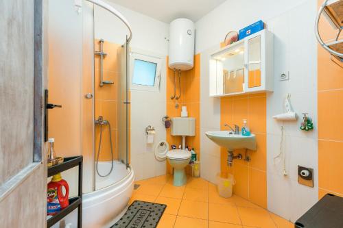 a bathroom with a shower and a toilet and a sink at Apartments by the sea Maslinica, Solta - 14748 in Maslinica