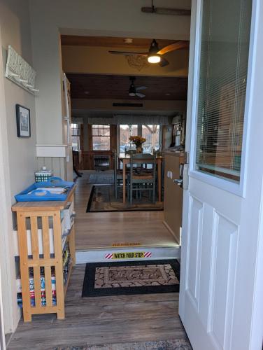 an open door to a kitchen and a dining room at Beach Cottage in Saco