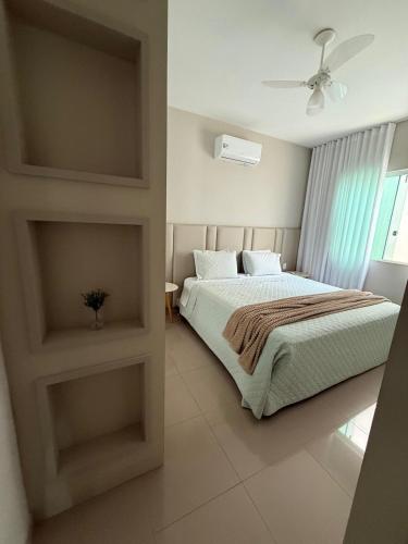 a bedroom with a bed and a window at Sweet Home Away from yours in Lagoa Santa