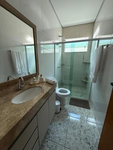 a bathroom with a sink and a shower and a toilet at Sweet Home Away from yours in Lagoa Santa