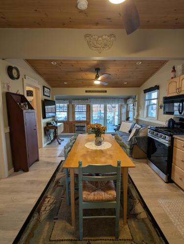 a kitchen and living room with a table and a couch at Beach Cottage in Saco