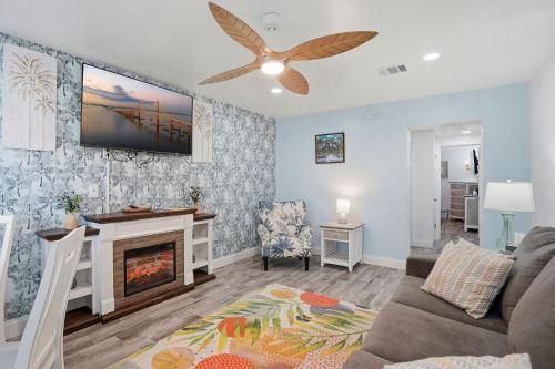 a living room with a couch and a fireplace at Malibu Resort Motel in St. Pete Beach
