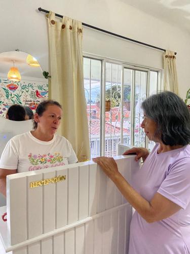 a woman standing in front of a mirror at La Casa Hostal Vijes in Vijes