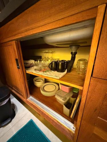 a cabinet filled with dishes and a pot at Estação Serra Negra in Bezerros