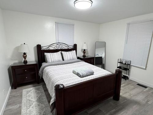 a bedroom with a large bed and two night stands at Completely renovated for you Mountain View Cottage in Charleston