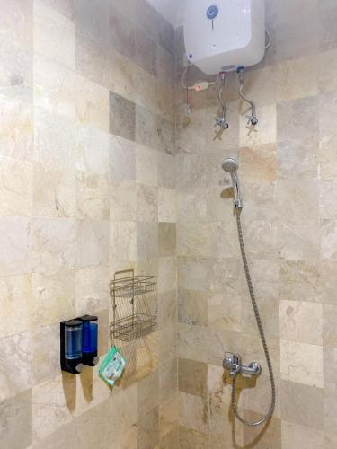 a shower in a bathroom with a shower at Al Andalus Resort Puncak in Puncak