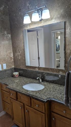 a bathroom counter with a sink and a mirror at Whale Hill Escape - Beach Views and Walk to Mannys in Puerto Peñasco