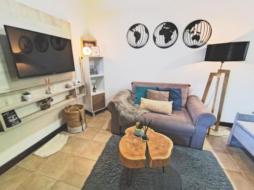 a living room with a couch and a table at Studio Monoambiente Urbano en radar centrico,completo y funcional con Alexa in Ushuaia