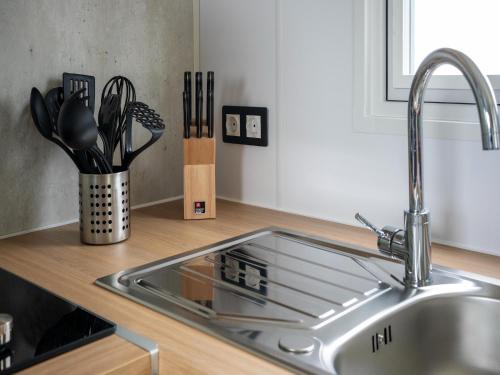 a kitchen counter with a sink and utensils at Berlare Retreat for 6 with garden in Berlare